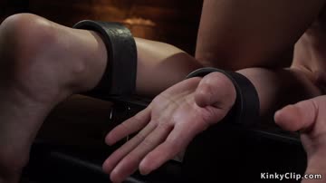 Shackled brunette gets ass whipped